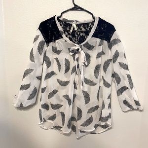 Woman’s black and white feather blouse